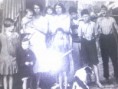 family in front of shantytown